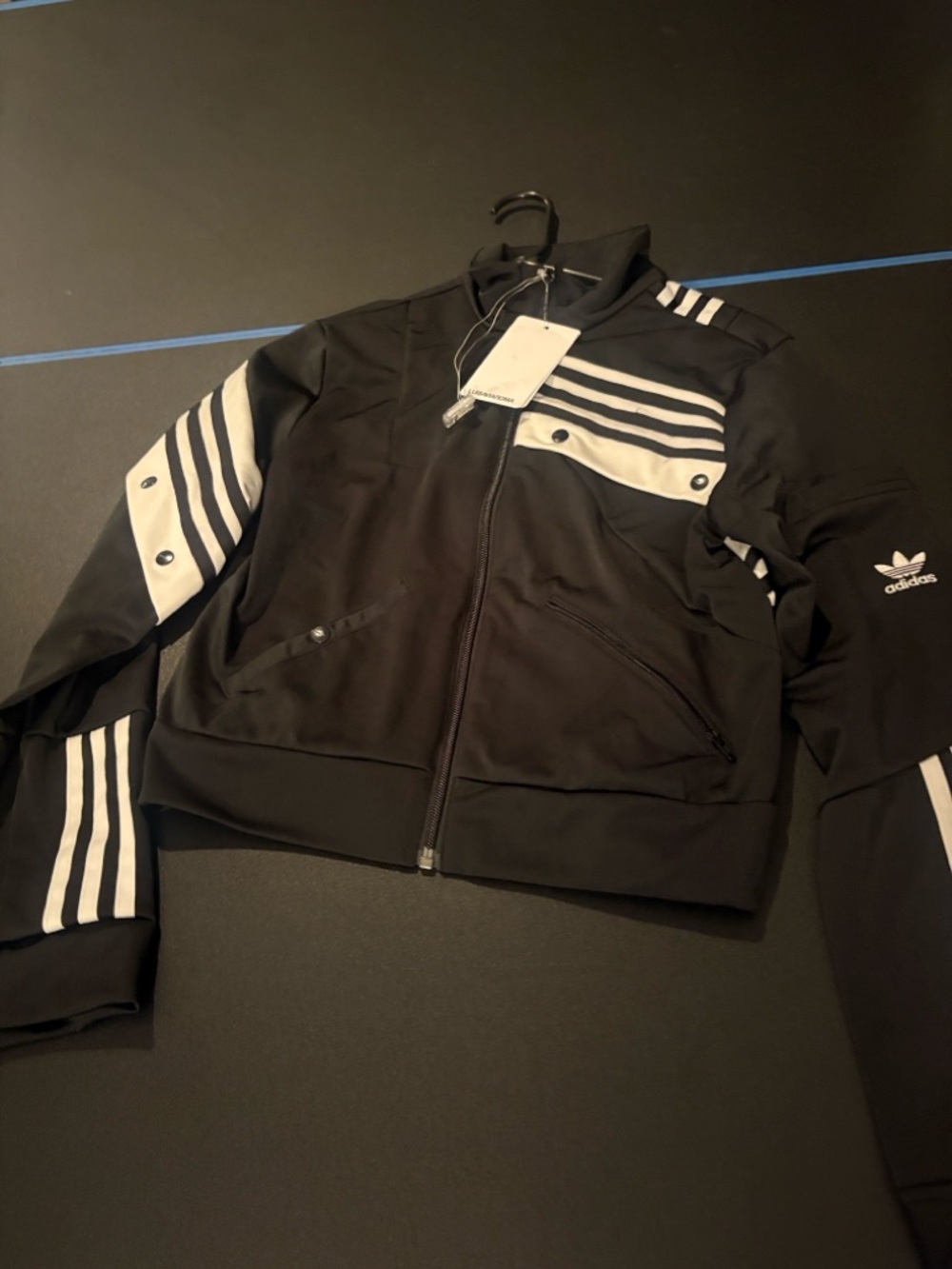 adidas Black Bomber Jacket with White Stripe Accents. D. Catharitt